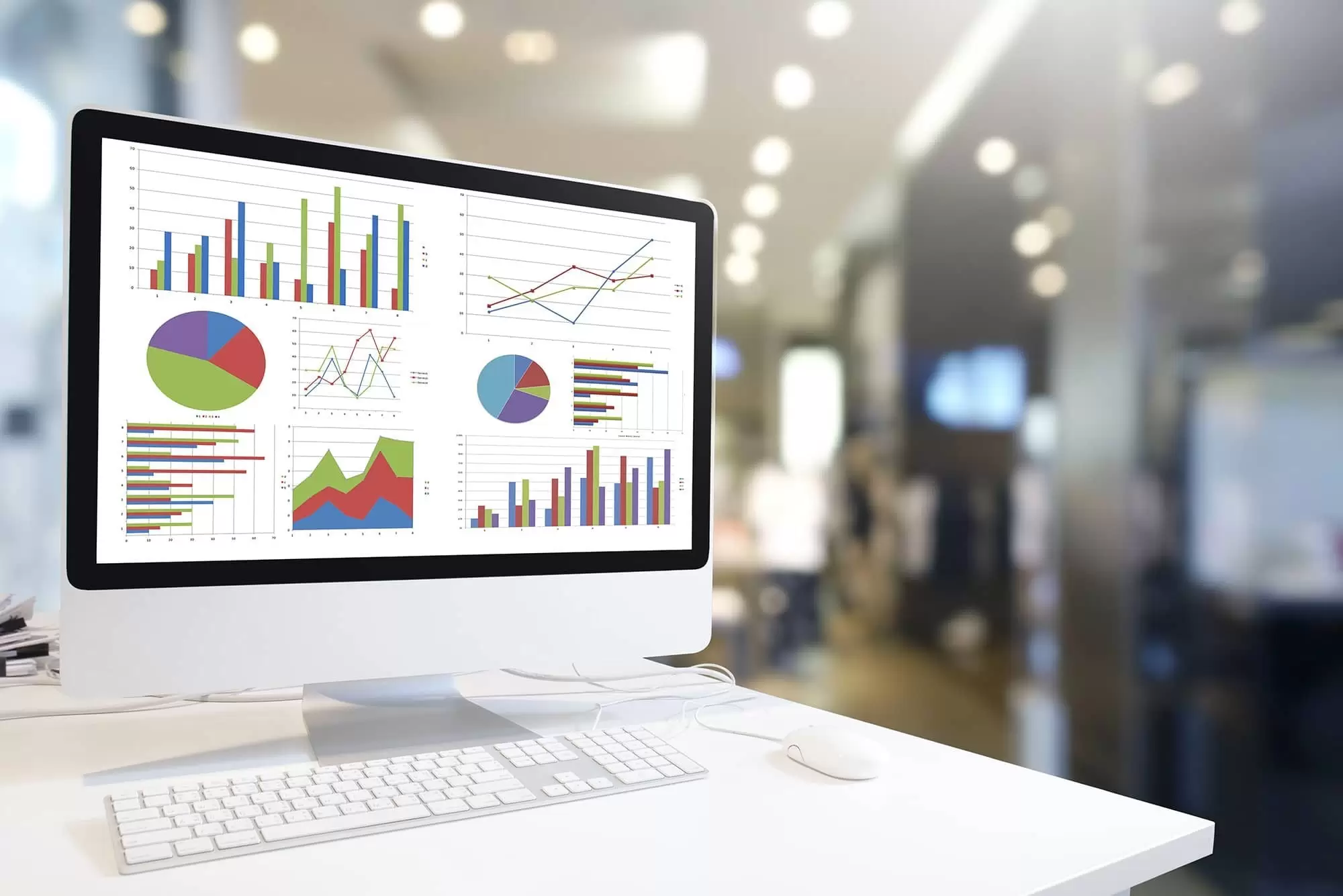 Fleet Monitoring and Driver Behaviour shown by a desktop disply with charts and graphs.
