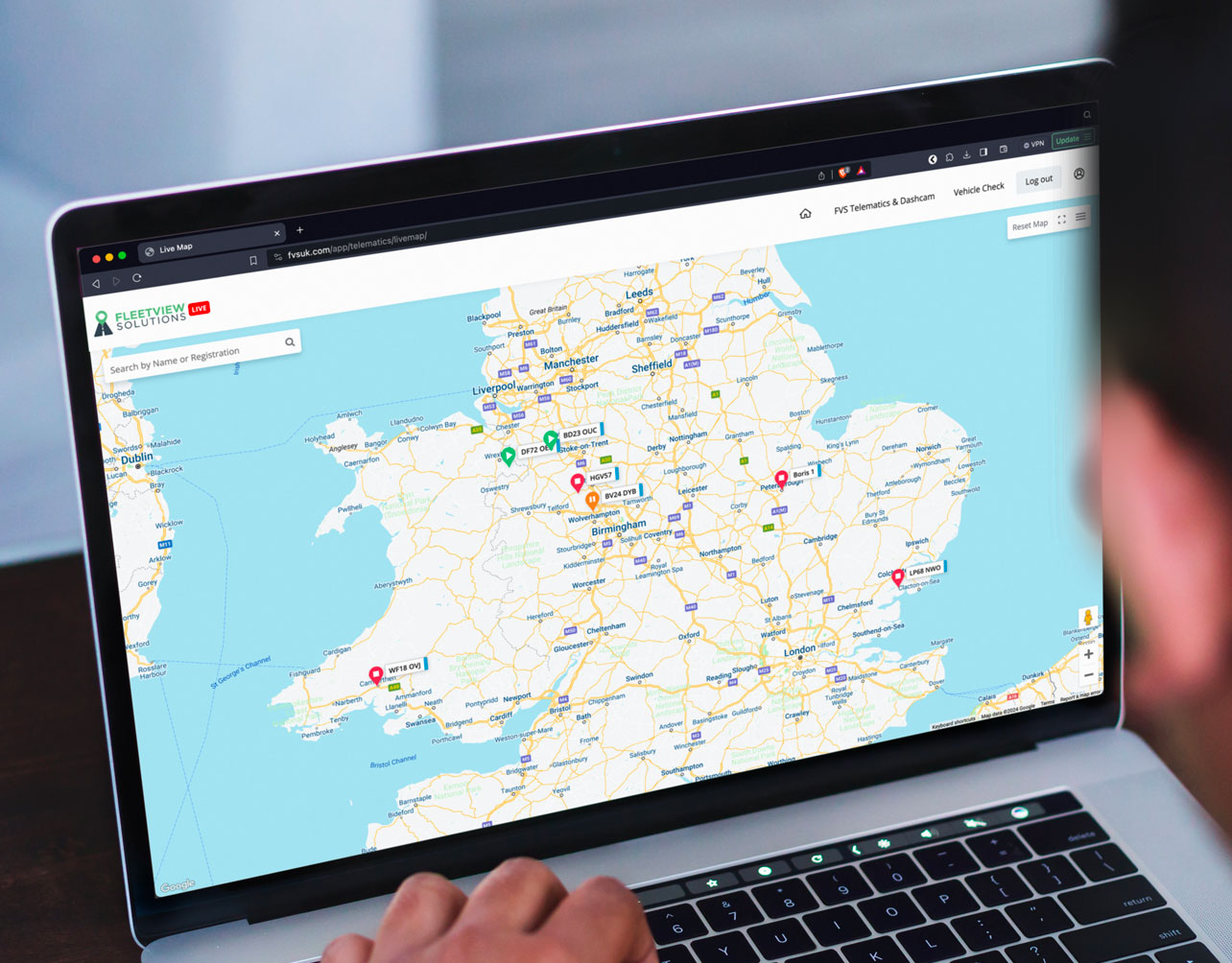 Serving Fleets Across the UK’s Regions shown by a man looking at a UK map om his computer.