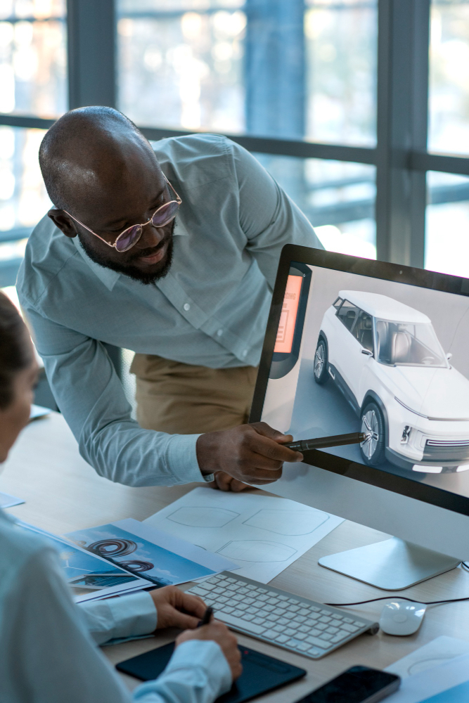 Fleetview shown by 2 people looking at a car on a screen.